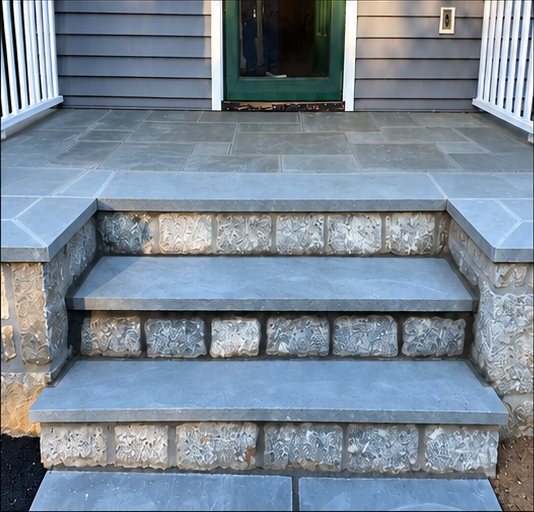 Rebuilt front entry steps in bluestone with a stone riser face