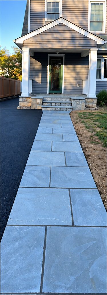 Bluestone walkway laid in large slabs leading from the driveway to the front porch